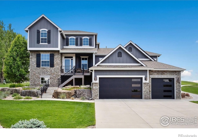 7427 Couples Ct, Fort Collins, CO 80528 - view of front of property with stone siding, stairs, a front yard, and an attached garage