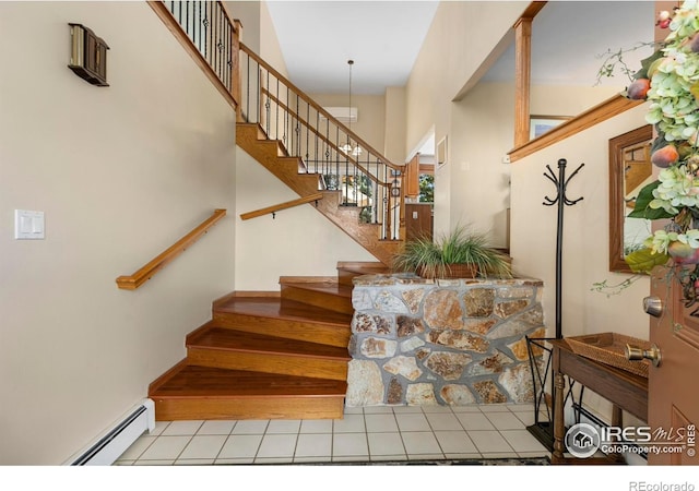 3804 Amy Pl, Loveland, CO 80538 - stairs featuring a baseboard radiator, tile patterned floors, and a towering ceiling