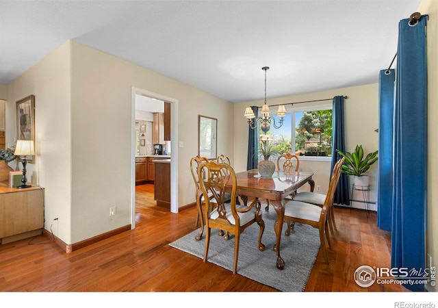 3804 Amy Pl, Loveland, CO 80538 - dining space with light wood-type flooring, a chandelier, a baseboard radiator, and baseboards