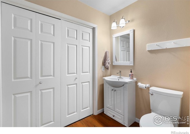 3804 Amy Pl, Loveland, CO 80538 - bathroom featuring toilet, vanity, a closet, and wood finished floors