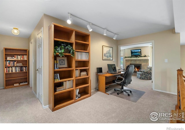 3804 Amy Pl, Loveland, CO 80538 - carpeted office space with rail lighting, a tile fireplace, and baseboards