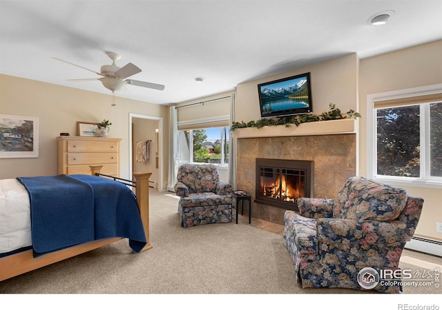 3804 Amy Pl, Loveland, CO 80538 - carpeted bedroom featuring a fireplace, a ceiling fan, and a baseboard heating unit