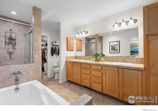 3804 Amy Pl, Loveland, CO 80538 - bathroom with a stall shower, toilet, double vanity, a garden tub, and tile patterned floors