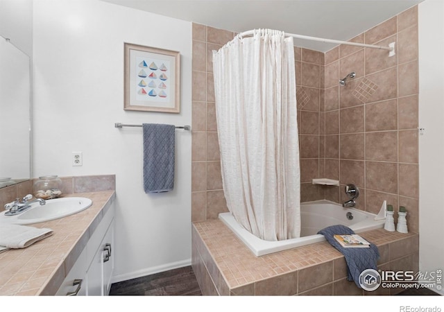 3804 Amy Pl, Loveland, CO 80538 - full bathroom with tiled shower / bath combo, vanity, wood finished floors, and baseboards