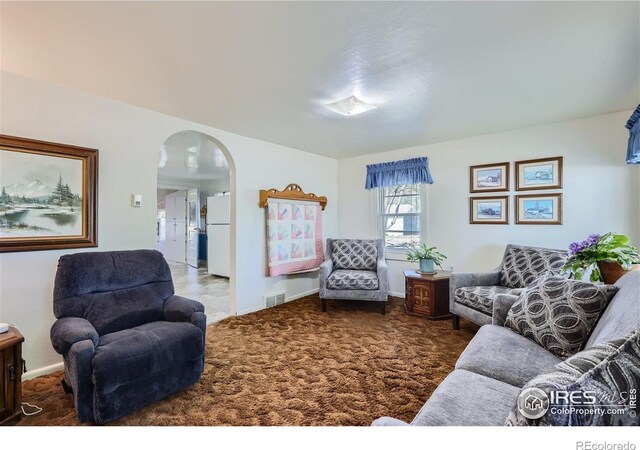 3833 Lincoln Ave, Wellington, CO 80549 - carpeted living area featuring arched walkways and baseboards