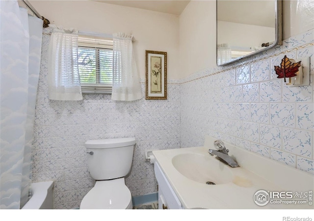 3833 Lincoln Ave, Wellington, CO 80549 - full bathroom with tile walls, toilet, vanity, and shower / bathtub combination with curtain