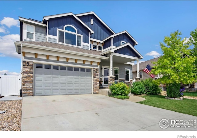 5664 Osbourne Dr, Windsor, CO 80550 - craftsman-style home featuring board and batten siding, stone siding, concrete driveway, and an attached garage