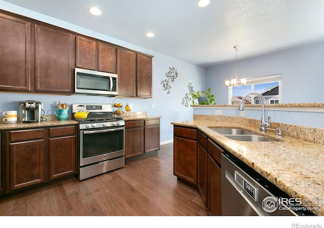 5664 Osbourne Dr, Windsor, CO 80550 - kitchen featuring stainless steel appliances, a sink, dark wood-style flooring, recessed lighting, and light stone countertops