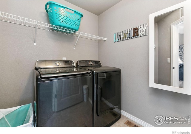 5664 Osbourne Dr, Windsor, CO 80550 - laundry room with washing machine and dryer and baseboards