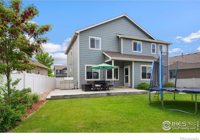 5664 Osbourne Dr, Windsor, CO 80550 - rear view of house with a trampoline and a patio