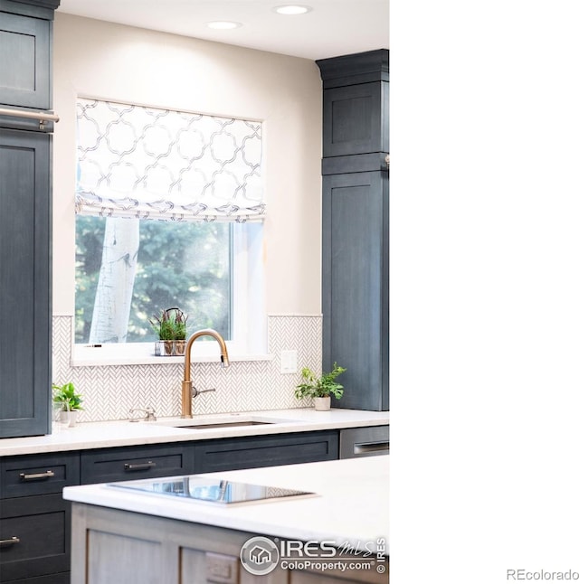 609 Corona Ct, Lafayette, CO 80026 - kitchen featuring a sink, light countertops, decorative backsplash, recessed lighting, and black electric stovetop