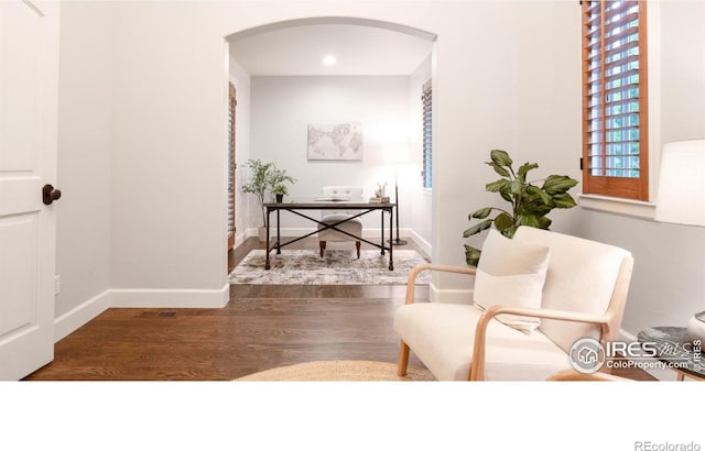 609 Corona Ct, Lafayette, CO 80026 - corridor with arched walkways, wood finished floors, baseboards, an office area, and recessed lighting
