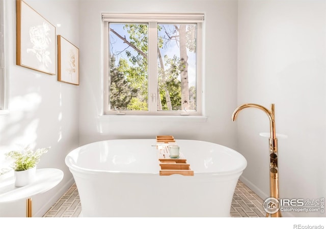 609 Corona Ct, Lafayette, CO 80026 - bathroom featuring a freestanding bath and baseboards