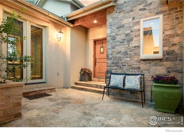 609 Corona Ct, Lafayette, CO 80026 - doorway to property with stone siding, stucco siding, and french doors