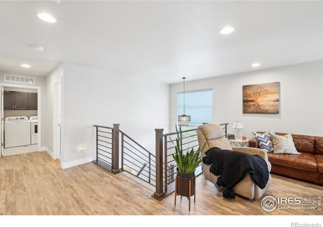 6211 Stable View St, Castle Pines, CO 80108 - living room featuring separate washer and dryer, light wood-style floors, baseboards, and recessed lighting