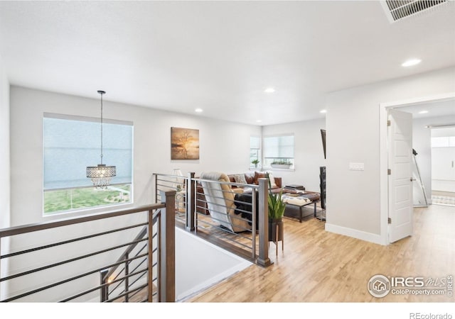 6211 Stable View St, Castle Pines, CO 80108 - living room with light wood-style flooring, healthy amount of natural light, recessed lighting, and a chandelier