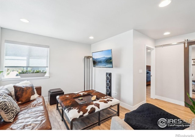 6211 Stable View St, Castle Pines, CO 80108 - living area featuring a barn door, light wood finished floors, recessed lighting, and baseboards