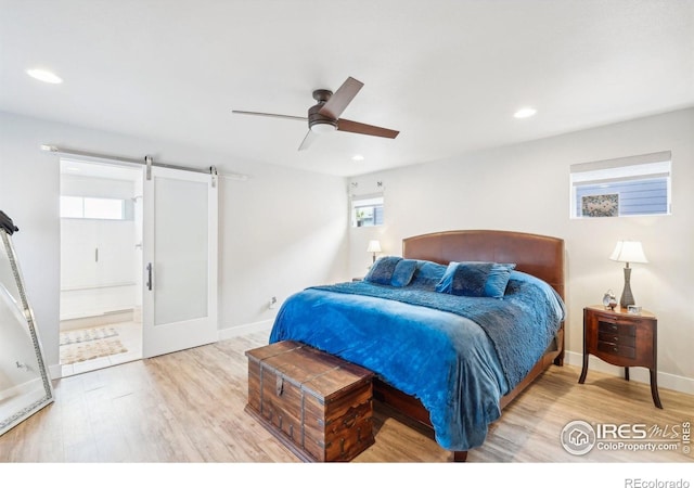 6211 Stable View St, Castle Pines, CO 80108 - bedroom with wood finished floors, baseboards, recessed lighting, and a barn door