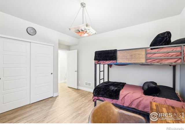 6211 Stable View St, Castle Pines, CO 80108 - bedroom with wood finished floors, a closet, and baseboards