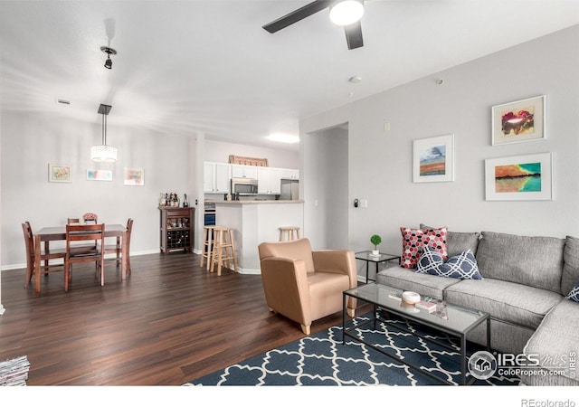 4451 S Ammons St Unit 307, Littleton, CO 80123 - living area with dark wood-style flooring, ceiling fan, and baseboards