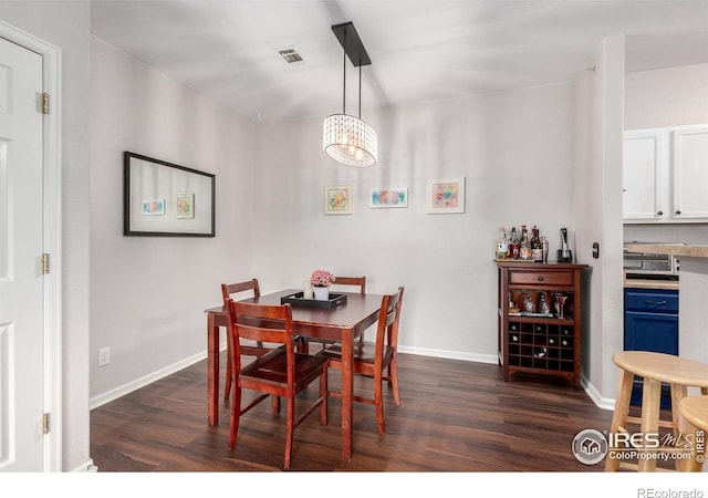 4451 S Ammons St Unit 307, Littleton, CO 80123 - dining area with dark wood-style floors, a chandelier, and baseboards