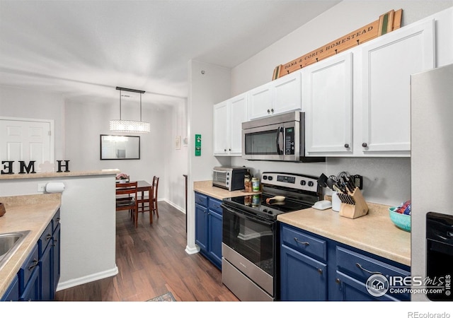 4451 S Ammons St Unit 307, Littleton, CO 80123 - kitchen featuring blue cabinets, appliances with stainless steel finishes, dark wood-style floors, and white cabinets