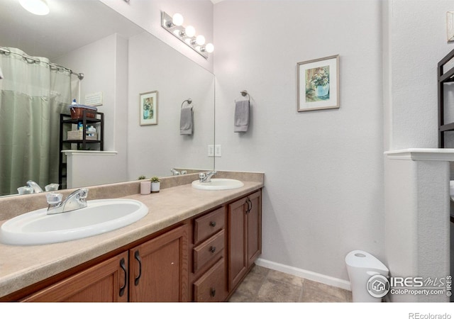4451 S Ammons St Unit 307, Littleton, CO 80123 - full bath featuring baseboards and double vanity