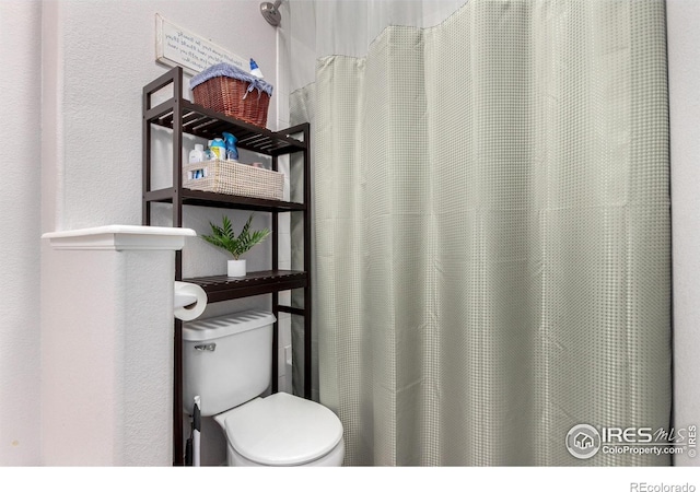 4451 S Ammons St Unit 307, Littleton, CO 80123 - full bathroom featuring toilet and a shower with shower curtain