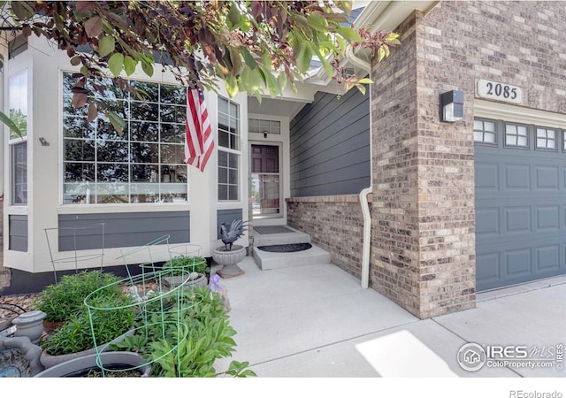 2085 Tundra Cir, Erie, CO 80516 - property entrance with brick siding and a garage