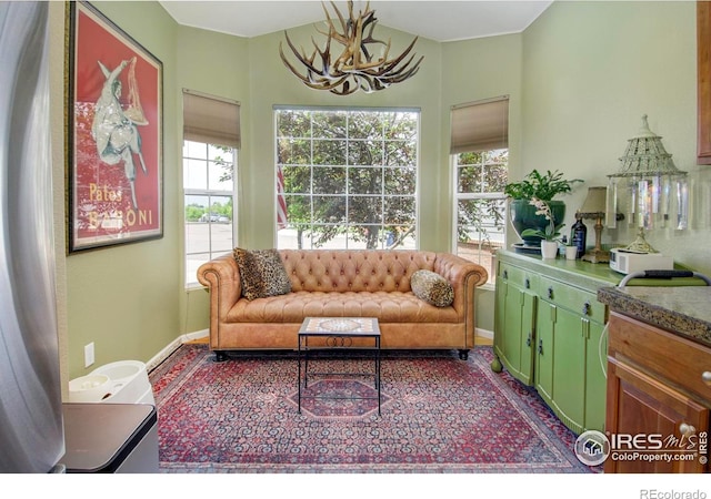 2085 Tundra Cir, Erie, CO 80516 - living area featuring a chandelier, plenty of natural light, and baseboards