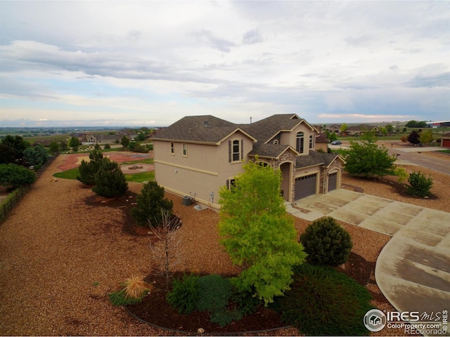 3106 Megan Way, Berthoud, CO 80513 - view of front facade featuring concrete driveway, stucco siding, and an attached garage