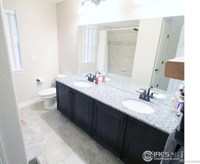 3106 Megan Way, Berthoud, CO 80513 - bathroom featuring double vanity, toilet, baseboards, and shower / bathtub combination with curtain
