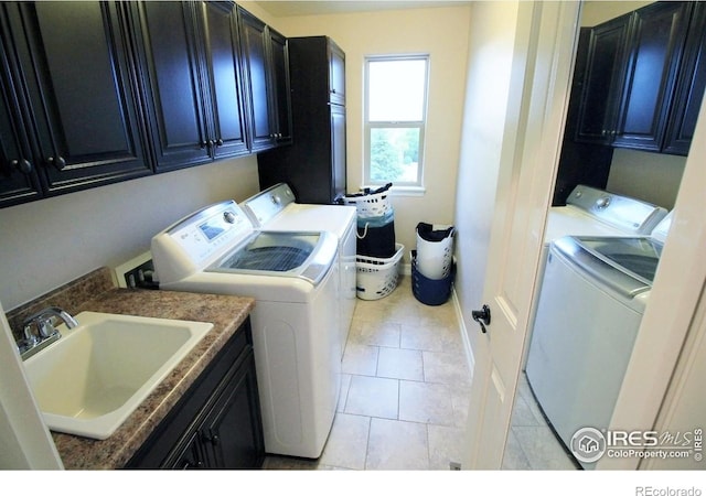 3106 Megan Way, Berthoud, CO 80513 - laundry room featuring washing machine and clothes dryer, cabinet space, and light tile patterned floors