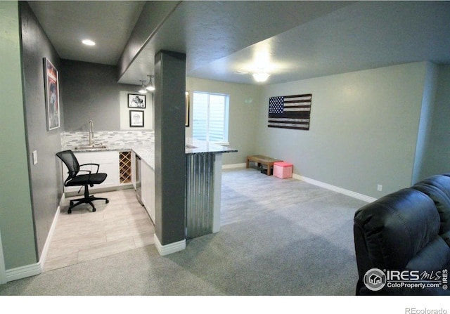 3106 Megan Way, Berthoud, CO 80513 - home office featuring light colored carpet, wet bar, and baseboards