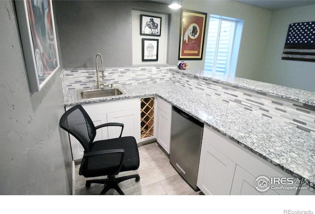 3106 Megan Way, Berthoud, CO 80513 - bar featuring stainless steel dishwasher, a sink, backsplash, and light tile patterned floors