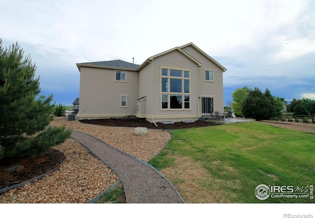 3106 Megan Way, Berthoud, CO 80513 - back of property featuring a yard, stucco siding, and a patio