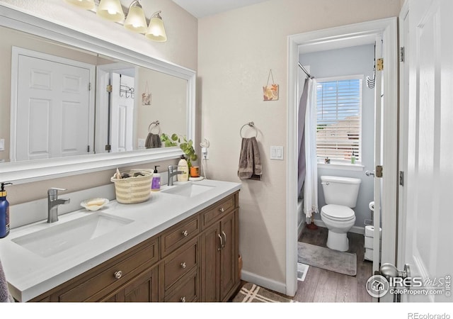 23570 E Holly Hills Way, Parker, CO 80138 - full bathroom with double vanity, wood finished floors, toilet, shower / bath combo, and baseboards