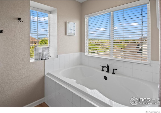 23570 E Holly Hills Way, Parker, CO 80138 - bathroom featuring a textured wall and a garden tub
