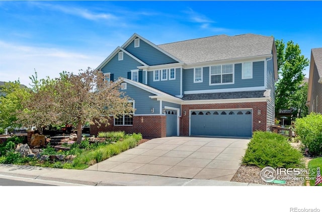 23570 E Holly Hills Way, Parker, CO 80138 - view of front of home with brick siding, an attached garage, concrete driveway, and roof with shingles