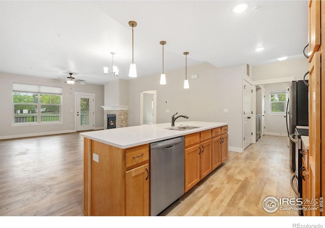 4672 Hahns Peak Dr Unit 101, Loveland, CO 80538 - kitchen with stainless steel dishwasher, a sink, ceiling fan, light wood-style floors, and recessed lighting
