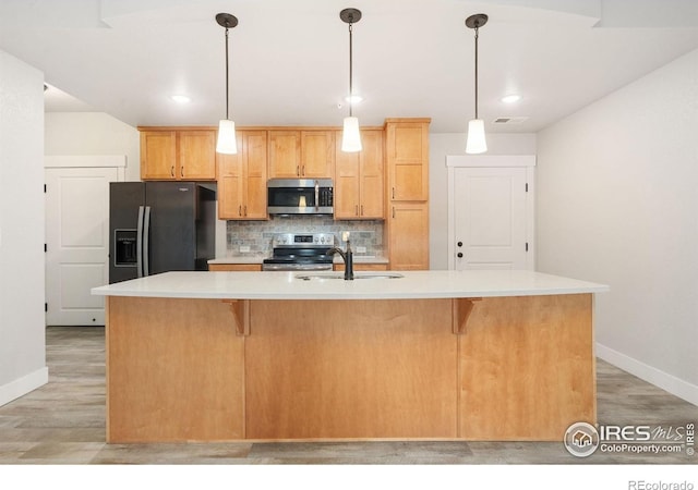 4672 Hahns Peak Dr Unit 101, Loveland, CO 80538 - kitchen with stainless steel appliances, a sink, baseboards, tasteful backsplash, and recessed lighting