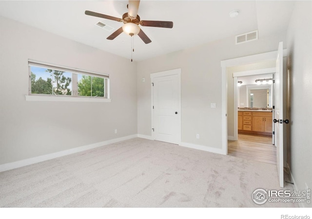 4672 Hahns Peak Dr Unit 101, Loveland, CO 80538 - unfurnished bedroom with light carpet, baseboards, and a ceiling fan