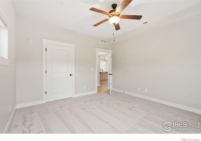 4672 Hahns Peak Dr Unit 101, Loveland, CO 80538 - unfurnished bedroom featuring carpet floors, baseboards, and ceiling fan
