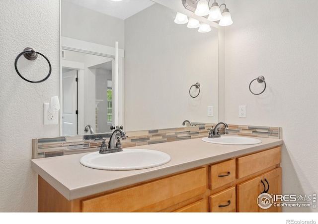 4672 Hahns Peak Dr Unit 101, Loveland, CO 80538 - bathroom with double vanity and a textured wall