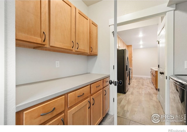4672 Hahns Peak Dr Unit 101, Loveland, CO 80538 - kitchen featuring stainless steel refrigerator with ice dispenser, stove, light countertops, light wood-type flooring, and dishwashing machine
