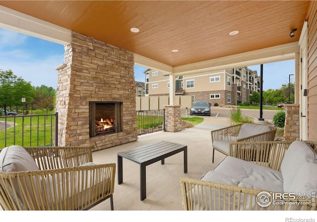 4672 Hahns Peak Dr Unit 101, Loveland, CO 80538 - view of patio / terrace featuring an outdoor living space with a fireplace