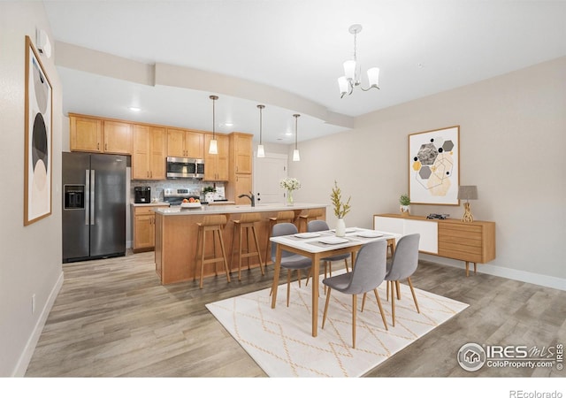 4672 Hahns Peak Dr Unit 101, Loveland, CO 80538 - dining space featuring light wood finished floors, a chandelier, recessed lighting, and baseboards
