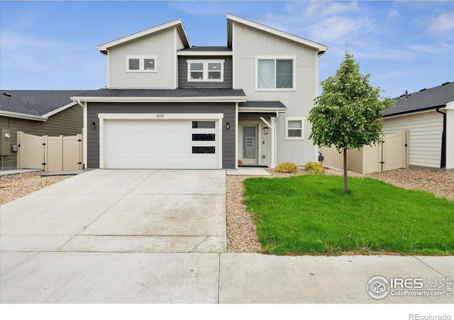 608 Apex Trl, Ault, CO 80610 - view of front facade featuring driveway, a gate, and a garage