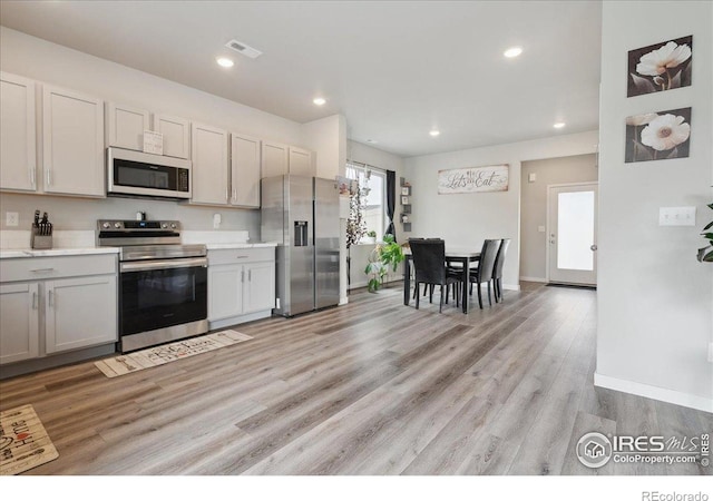 608 Apex Trl, Ault, CO 80610 - kitchen featuring stainless steel appliances, light wood-style flooring, light countertops, recessed lighting, and baseboards