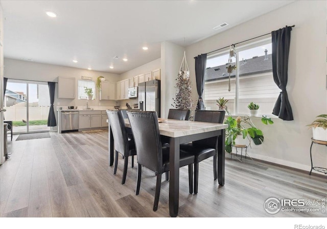 608 Apex Trl, Ault, CO 80610 - dining space with light wood finished floors, recessed lighting, and baseboards